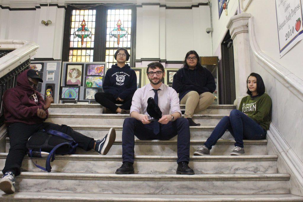Mr. Fantini and the newly formed poetry club sit on the marble stairs. Contributing photographer Skyelar Decker. Note: a previous version of this article misspelled the photographers name. 
