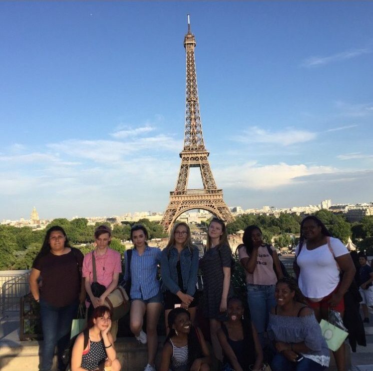 The FLC travel club poses in front of the Eiffel Tower. 