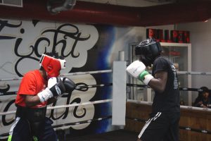 Boxer and FLC Alumni, Aanjhrue Williams, (right) spars at Rock Ministries Boxing Gym on October 10. · Sandraliz Flores / STAFF