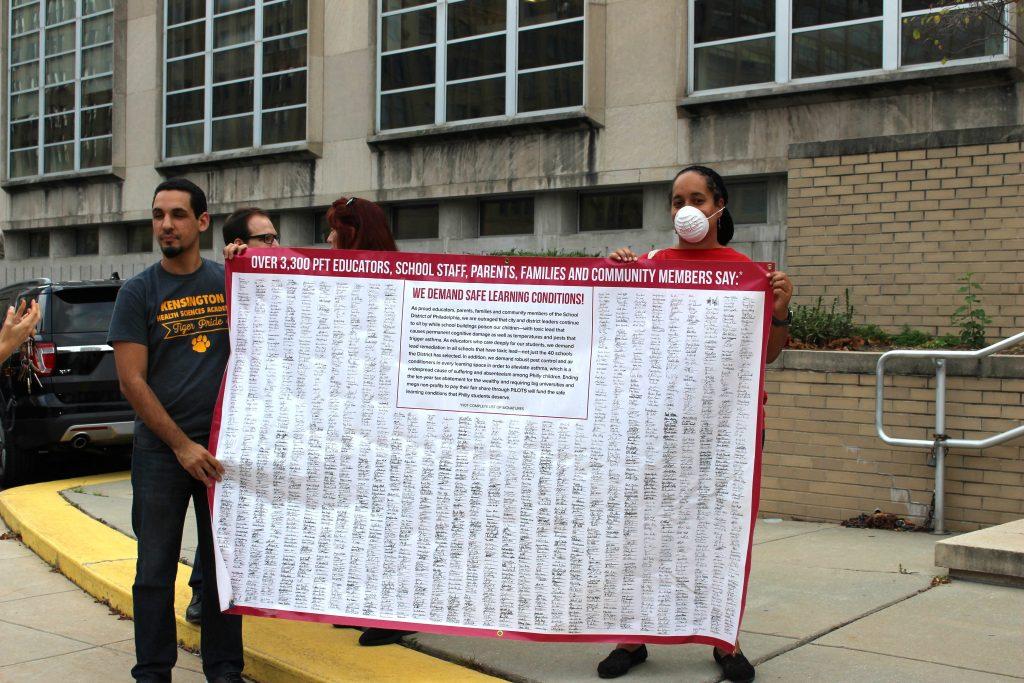 Protesters gather in front of the 440 building on October 7 with a petition signed by over 3,300 teachers, staff and community members to protest the conditions of their students school. · Deja Dawkins / STAFF