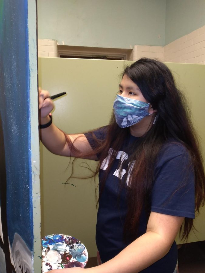 Mural club member, Naomi Hoover painting girls’ bathroom. 