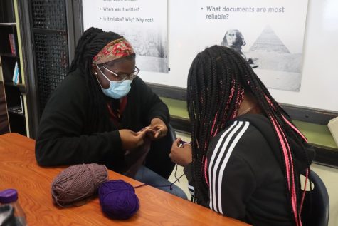 2 student members of the FLC craft club, run by Ms. Felber in room 212, improve their crochet skills together.