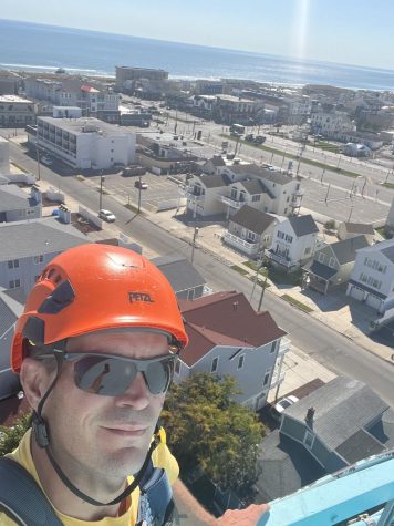 Mike Wallace who has been in the tower industry for 11 years shows off the great view of what its like being up above.