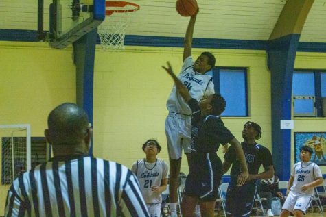 Kadeem Martin jumps up to dunk on an opposing player in the final quarter of the game. 