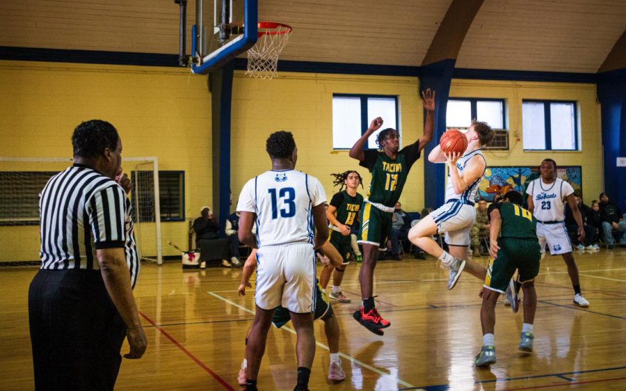 Dominic DiGiorgio forcefully jumps up into the air attempting to shoot over the Tacony Lions during a non-conference home game. 