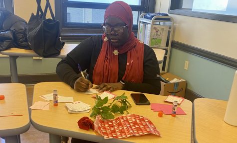 Senior HOSA member Rokhaya Mbengue works on selling roses and candy grams during valentine’s day in attempt to raise money for HOSA’s national leadership conference.