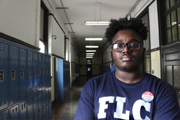 A 2019 FLC student voter who is showing off his registered voter sticker.
